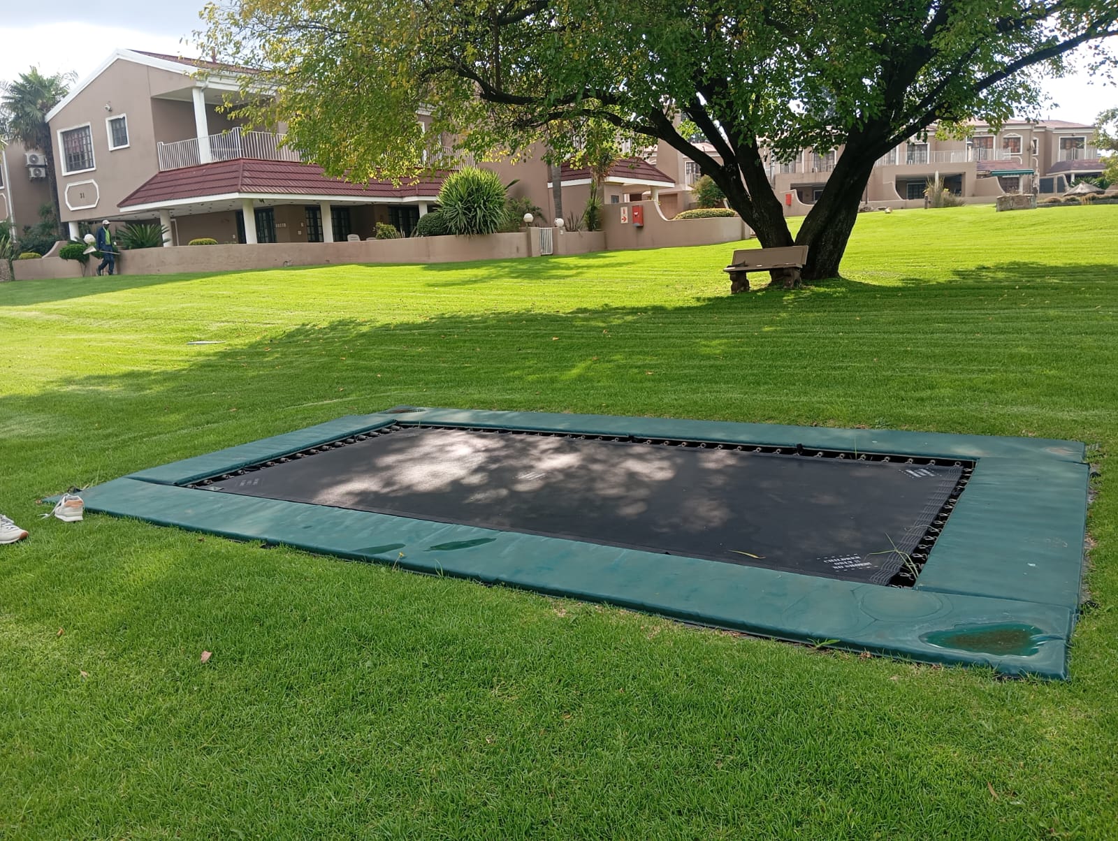 Villa in-ground trampoline on the estate lawn